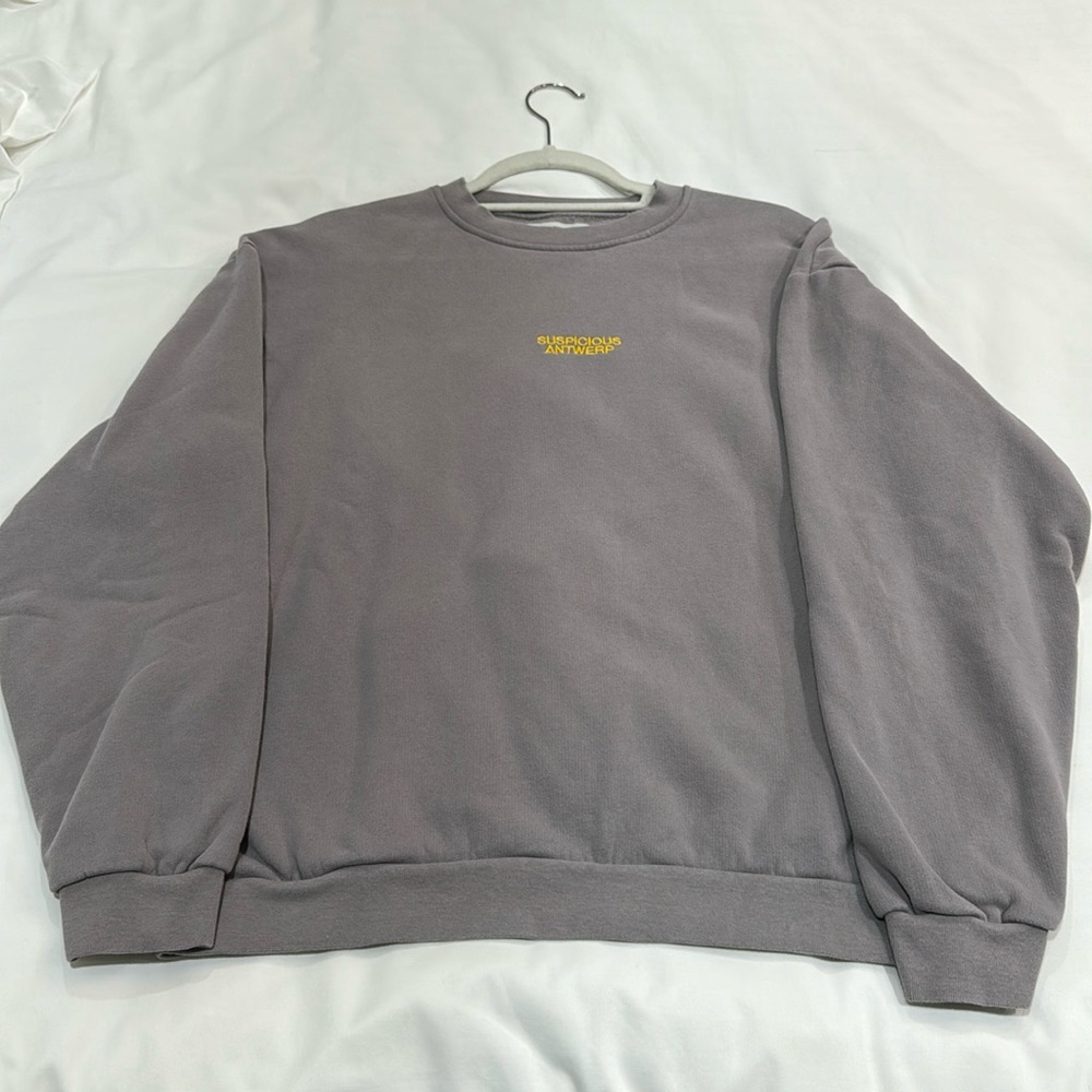 Suspicious Antwerp 
“Courage Capsule" Heart Ribbon Unisex Sweater (color Stone)